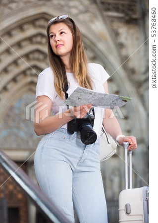 Cheerfull woman tourist holding map in hands 53768460