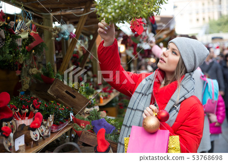Girl shopping Christmas decorations 53768698
