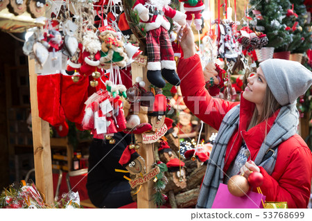 Girl shopping Christmas decorations 53768699