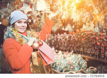 Girl shopping Christmas decorations 53768958