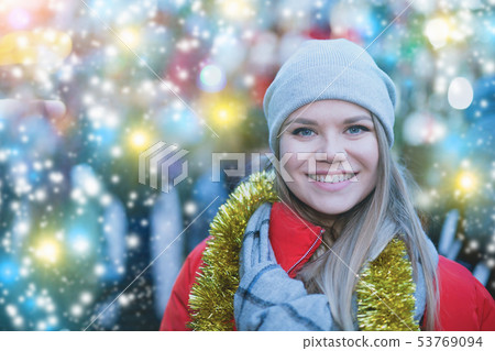 Positive smiling woman at fair near counter with Christmas gifts Positive smiling woman at fair near counter with Christmas gifts 53769094