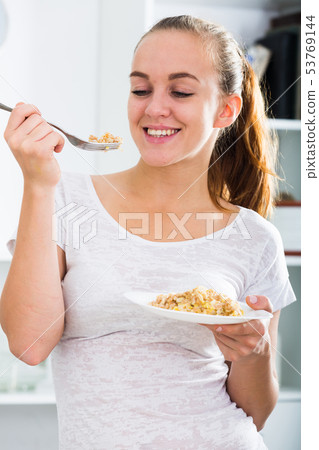 Girl eating porrige Girl eating porrige 53769144