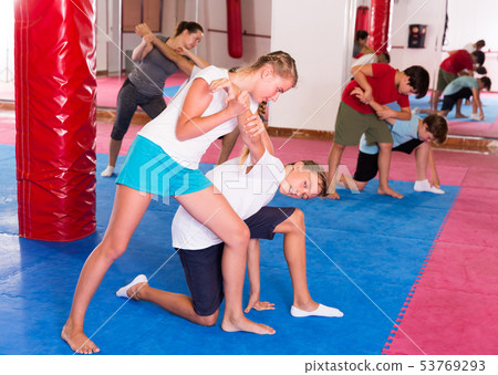 Kids exercising self-defense movements 53769293