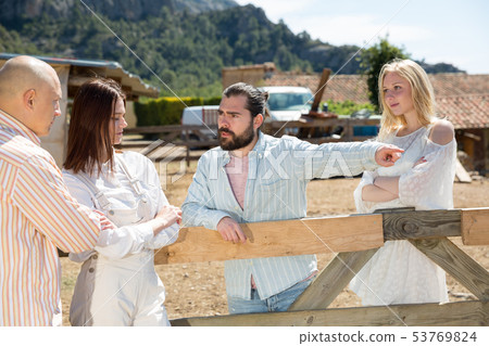 Adults having unpleasant conversation outdoors 53769824