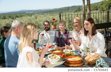 Friends having lunch on the open-air terrace 53769885