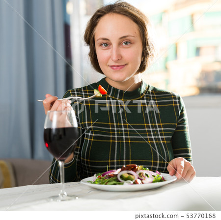 Woman eating salad and drinking wine Woman eating salad and drinking wine 53770168