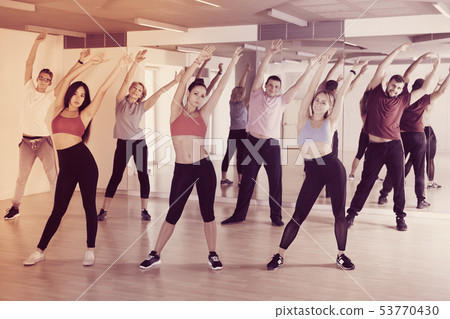 adults of different ages dancing at dance class 53770430