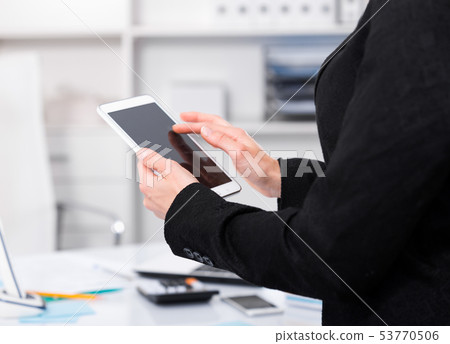 Female testing modern touchscreen Female testing modern touchscreen 53770506