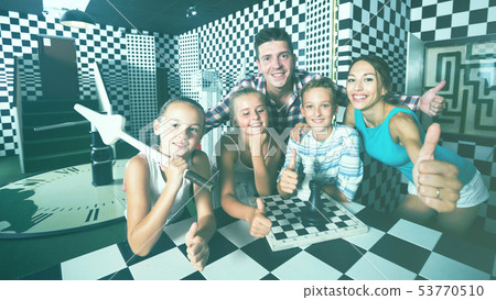 Parents with their children are satisfied after visit of escape room 53770510