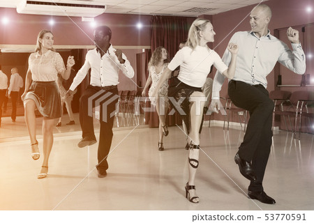 Young positive people dancing twist together at modern dance studio 53770591