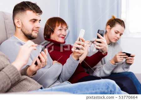 Happy family with phone at home 53770664