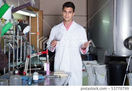 Attentive male laboratorian working with wine 53770799