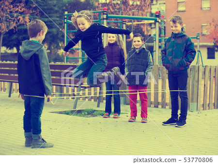 Ordinary children skipping on jumping rope Ordinary children skipping on jumping rope 53770806