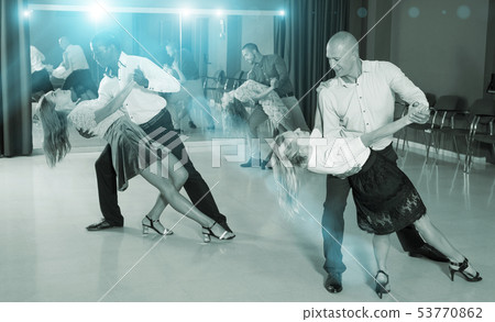 Couples enjoying latin dances Couples enjoying latin dances 53770862