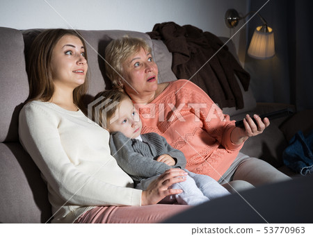 Family is watching emotional film in evening 53770963