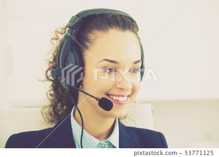 girl with headset and laptop in office. girl with headset and laptop in office. 53771125