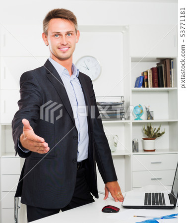 Business man standing with desk Business man standing with desk 53771181