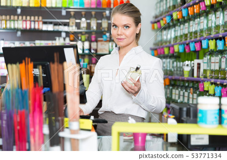 Salesgirl at workplace in perfume shop 53771334