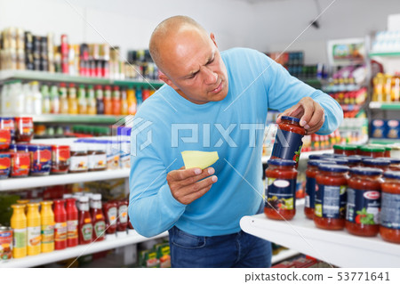 Man buying food in supermarket 53771641