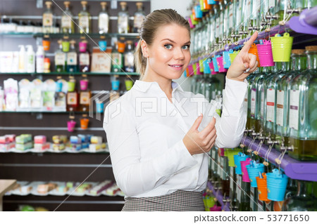Saleswoman filling perfume bottle Saleswoman filling perfume bottle 53771650