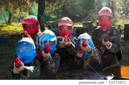 Kids paintball players aiming outdoors Kids paintball players aiming outdoors 53771651