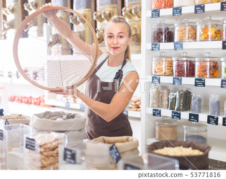 Portrait of girl seller who is standing with ring for grind Portrait of girl seller who is standing with ring for grind 53771816