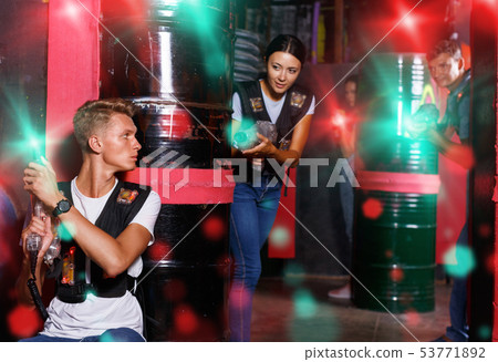 Portrait of friends standing with laser guns during laser tag g 53771892
