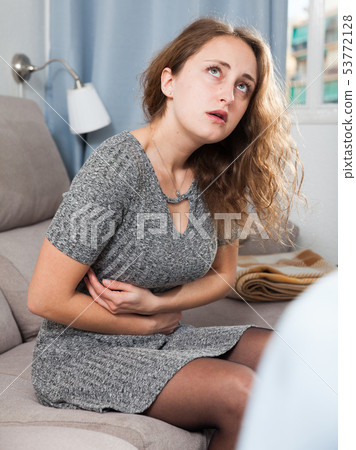 Woman suffering from abdominal pain 53772128