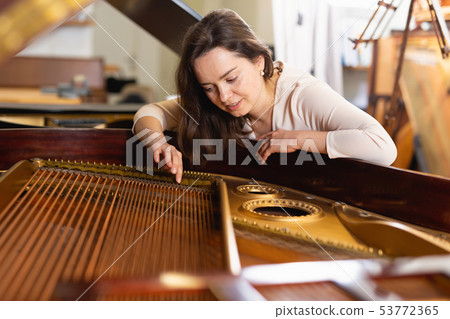 Portrait of pretty woman in music store Portrait of pretty woman in music store 53772365