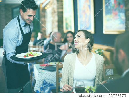 waiter man serving company at restaurant waiter man serving company at restaurant 53772575