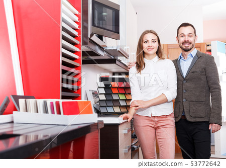 Family couple in kitchen furniture salon Family couple in kitchen furniture salon 53772642