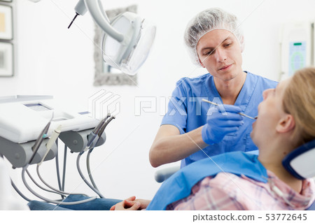 Young woman on dental checkup in modern dentist office Young woman on dental checkup in modern dentist office 53772645