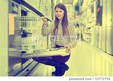 Smiling woman choosing dishwashing machine 53772756