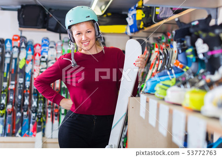 Portrait of girl in helmet who is standing with ski Portrait of girl in helmet who is standing with ski 53772763