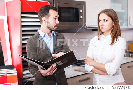 Unhappy woman in store kitchen furnishings 53772928