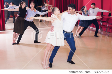 Dancing couples enjoying latin dances Dancing couples enjoying latin dances 53773026