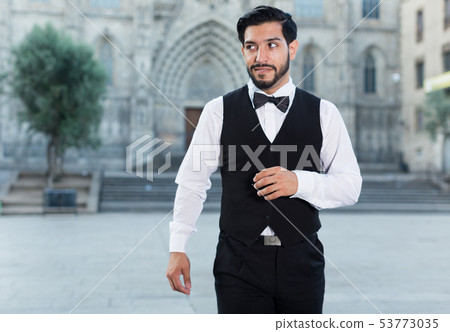 Portrait of man in bow tie outdoors 53773035