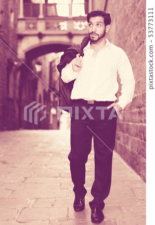 Man walking along old town street Man walking along old town street 53773111
