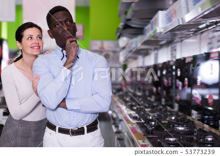 Happy couple chooses cooktop in store Happy couple chooses cooktop in store 53773239