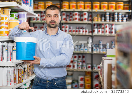 Man is standing with paint for repair Man is standing with paint for repair 53773243