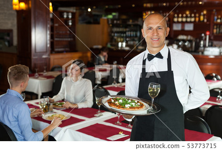Waiter with tray in restaurant 53773715
