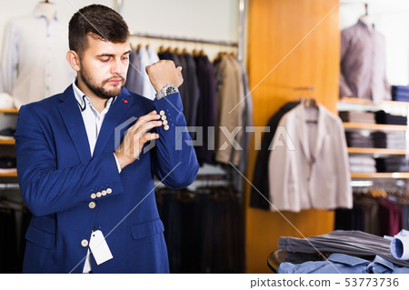 Male customer choosing jacket in men fashion store 53773736