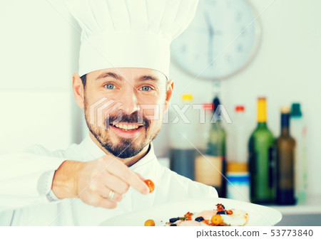 Male cook preparing food Male cook preparing food 53773840