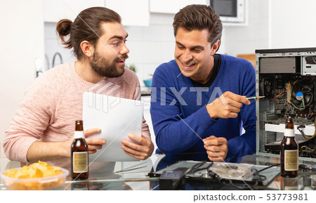 Men drink beer and repair the desktop computer Men drink beer and repair the desktop computer 53773981