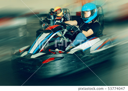 Glad woman driving sport car in a circuit lap Glad woman driving sport car in a circuit lap 53774047