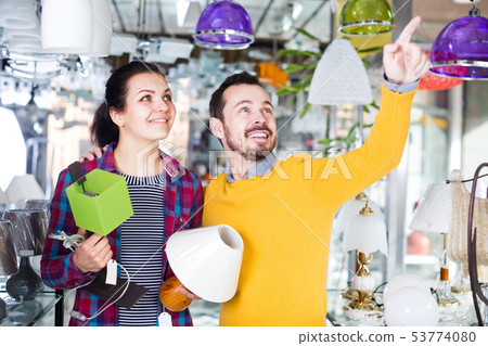 Man and woman with are looking at lamps Man and woman with are looking at lamps 53774080