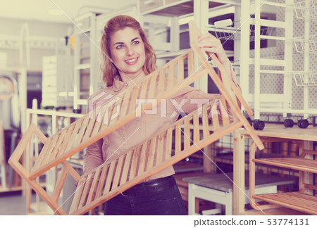 Woman choosing shoe rack in store Woman choosing shoe rack in store 53774131