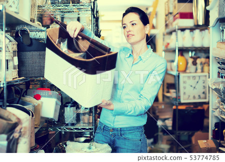 Young woman choosing purpose basket Young woman choosing purpose basket 53774785