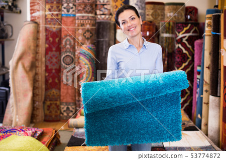 Female touching and choosing carpets Female touching and choosing carpets 53774872