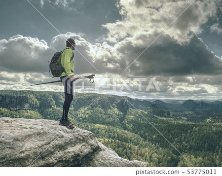 Skarner climb on mountain with trekking poles and Skarner climb on mountain with trekking poles and 53775011